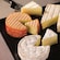 A variety of cheeses placed on a board for sampling